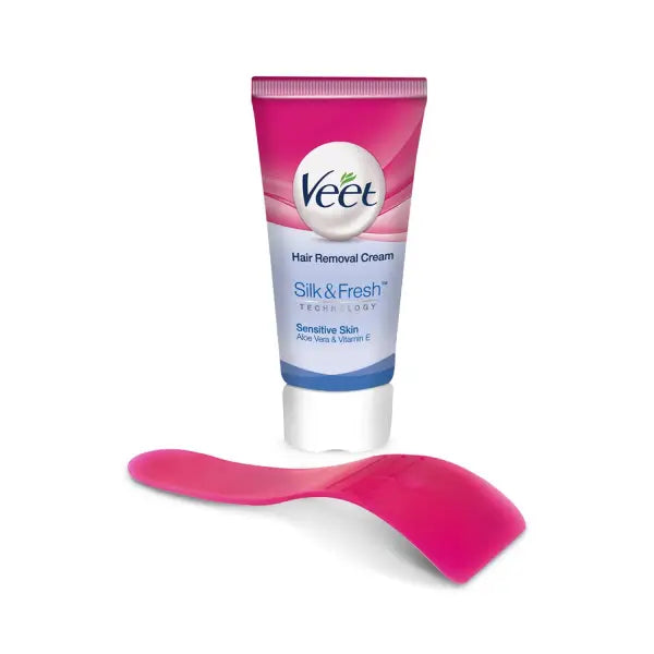 Veet hair removal cream tube with applicator on a white background
