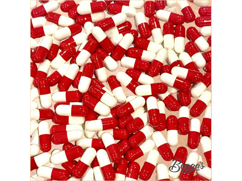 Close-up view of red and white capsules representing Bagga's Magnesium Bisglycinate Capsules (Refill), highlighting the supplement form for expert medication support at Woden Compounding Pharmacy.
