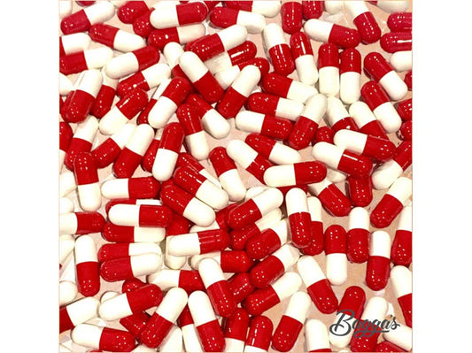 Close-up view of red and white capsules representing Bagga's Magnesium Bisglycinate Capsules (Refill), highlighting the supplement form for expert medication support at Woden Compounding Pharmacy.