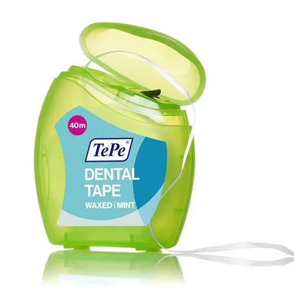 TePe dental tape container with green lid and white tape on a white background